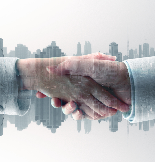 Handshake in front of city buildings representing partnership, trust, and expert trade solutions